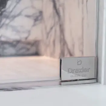 Drexler logo on a piece of hardware for the shower.