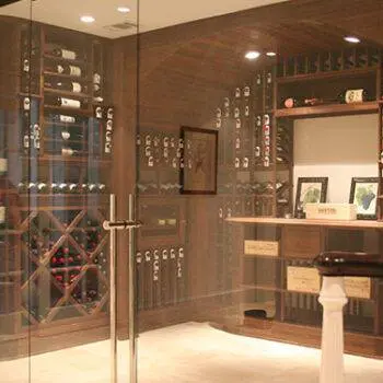 Glass window and door enclosing a residential wine cellar.