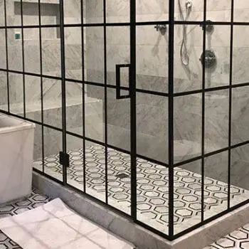 Wall to wall glass shower with black accent panels resembling a window.